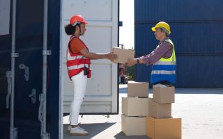 Businessman older boss manager company office wear hat helmet sa Businessman older boss manager company office wear hat helmet safety is carring boxes packaging order service logistic cargo import export female black skin south african at warehous container